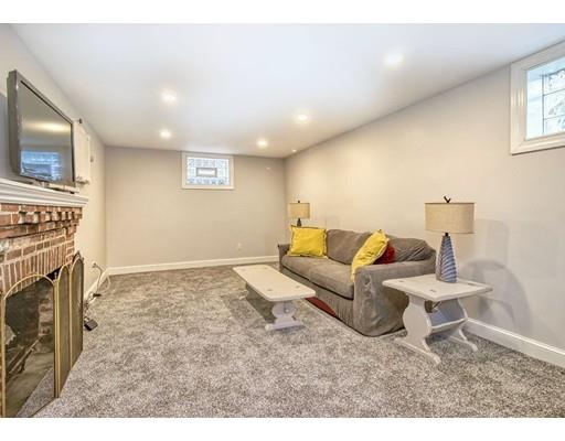 210 Varick Road Newton, MA 02468 - Photo 14 of 19 a living room with furniture a flat screen tv and a fireplace