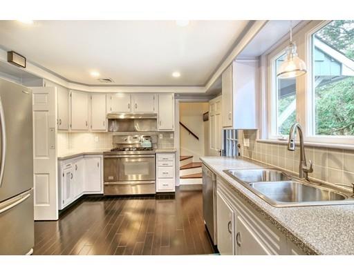 210 Varick Road Newton, MA 02468 - Photo 3 of 19 a kitchen with stainless steel appliances granite countertop a sink cabinets and wooden floor