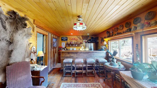 a dining room with furniture a rug and a chandelier