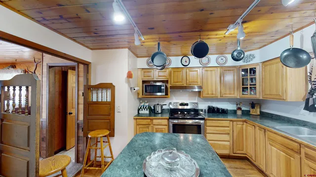 a kitchen with stainless steel appliances granite countertop a stove and a sink
