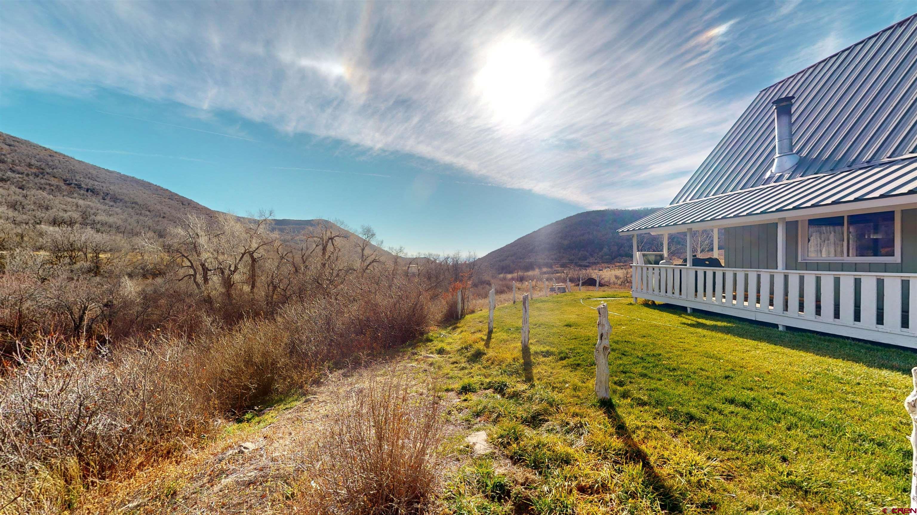 19253 Stevens Gulch Road Paonia, CO 81428 - Photo 22 of 45 a view of a swimming pool with a house