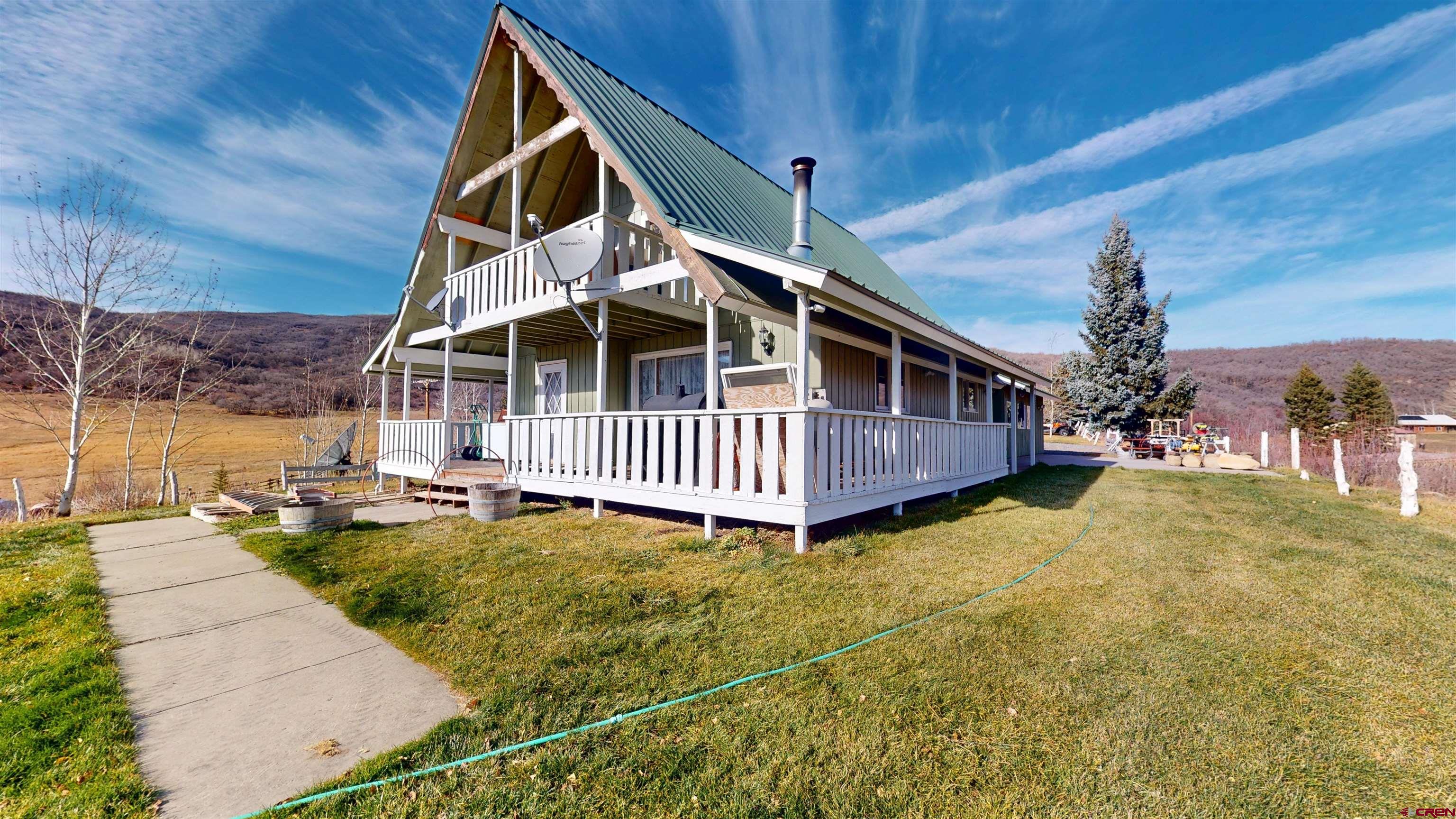 19253 Stevens Gulch Road Paonia, CO 81428 - Photo 26 of 45 a view of a house with backyard and sitting area