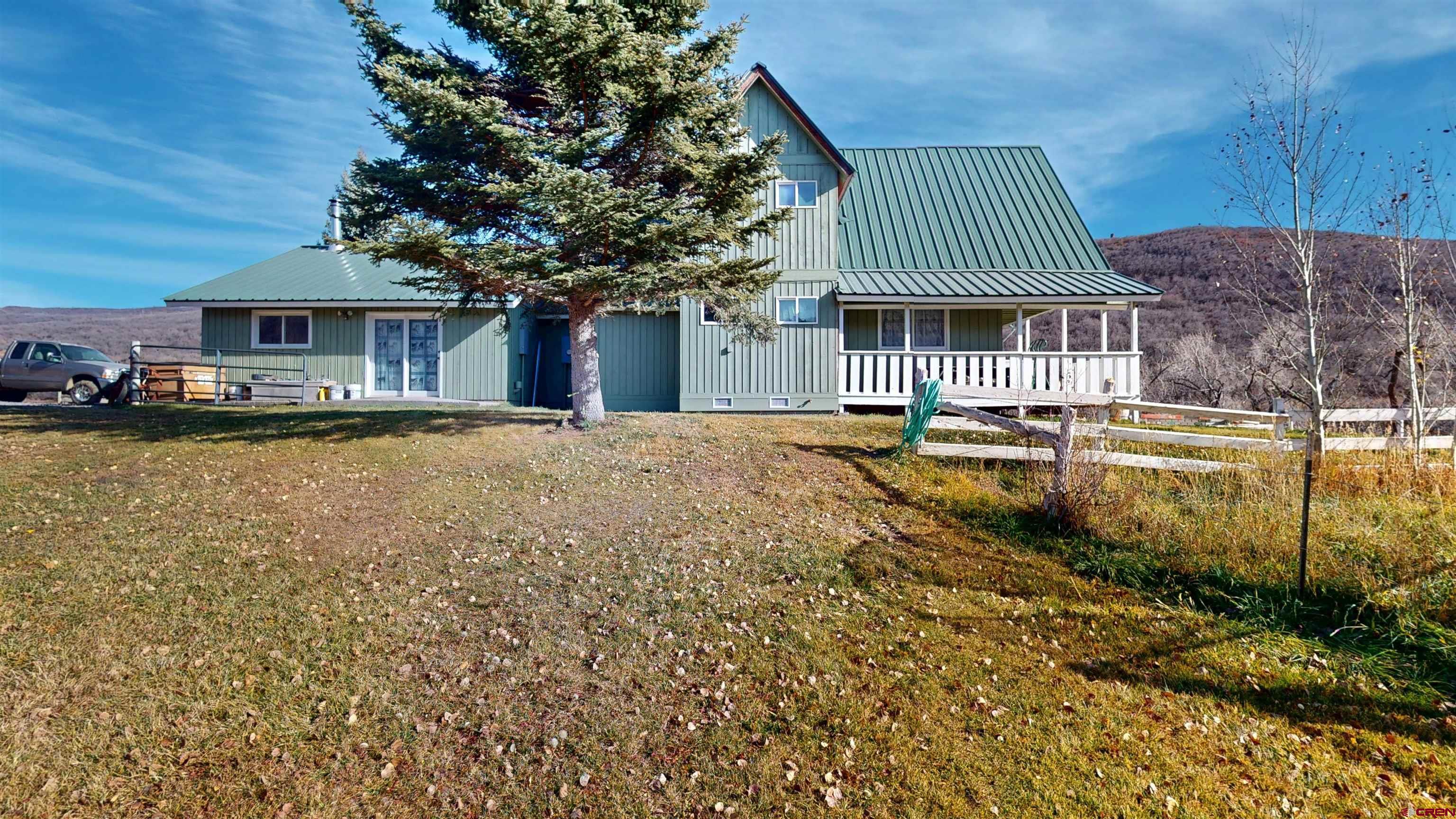 19253 Stevens Gulch Road Paonia, CO 81428 - Photo 27 of 45 a front view of a house with a garden