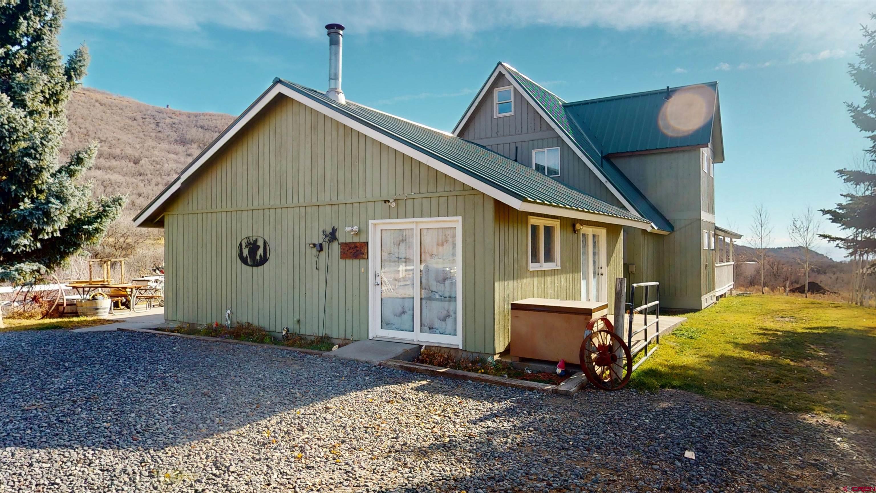 19253 Stevens Gulch Road Paonia, CO 81428 - Photo 29 of 45 a view of a house with a yard