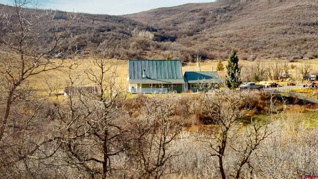 a view of house with a yard