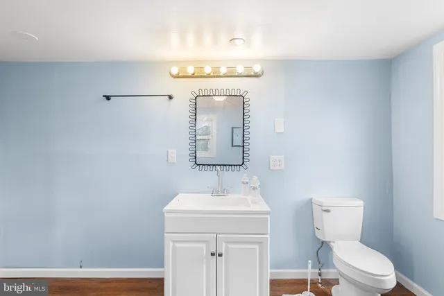 a view of a room with wooden floor and white walls