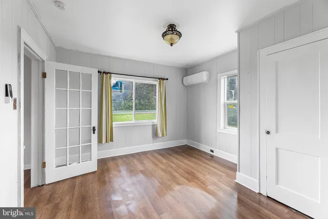a view of a house with a yard and potted plants
