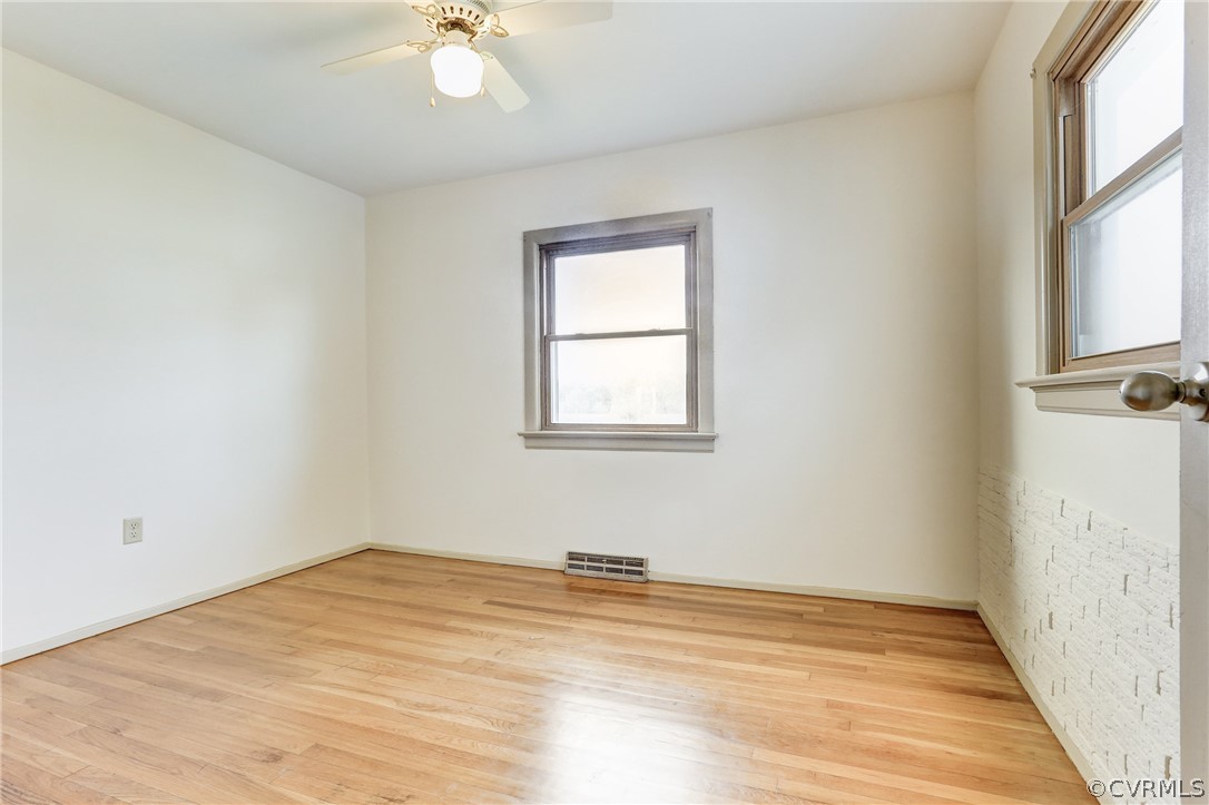 6228 Cross County Road Mineral, VA 23117 - Photo 24 of 26 a view of a room with wooden floor and a ceiling fan