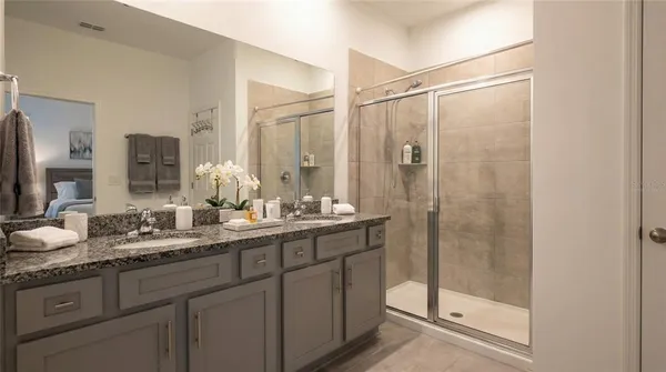 a bathroom with double sink and a mirror