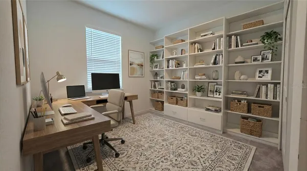 a view of a workspace with furniture and bookshelf