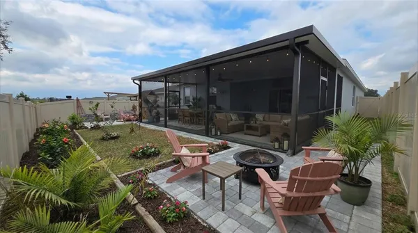 a terrace with outdoor seating and trees