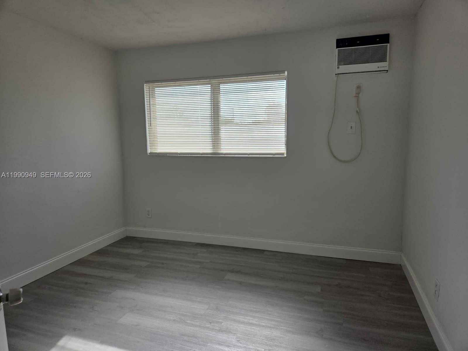 1628 Southwest 7th Street, Unit 8 Miami, FL 33135 - Photo 5 of 8 a view of a room with wooden floor and window