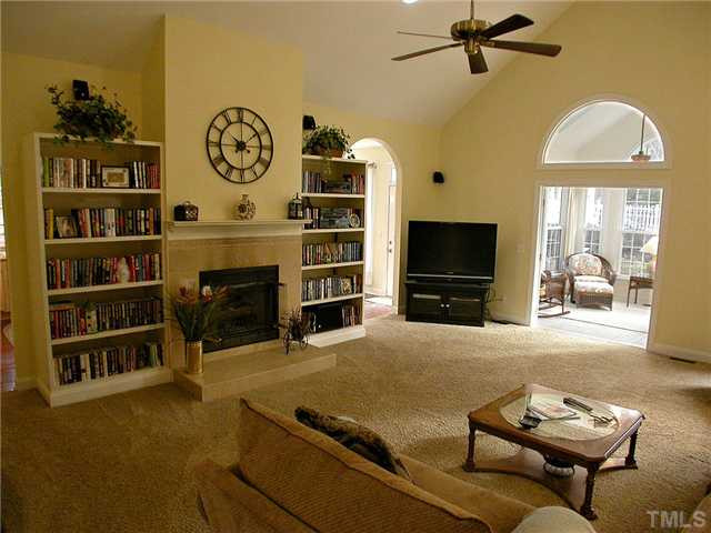 6812 Cool Pond Road Raleigh, NC 27613 - Photo 4 of 25 Great Room has Gas-log Fireplace flanked by Bookshelves + 5 Speaker Surround Sound System Den/Family/Great Room