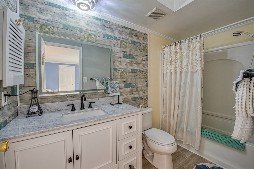 191 Red Oak Terrace Taunton, MA 02780 - Photo 14 of 28 a bathroom with a granite countertop toilet a sink and a mirror