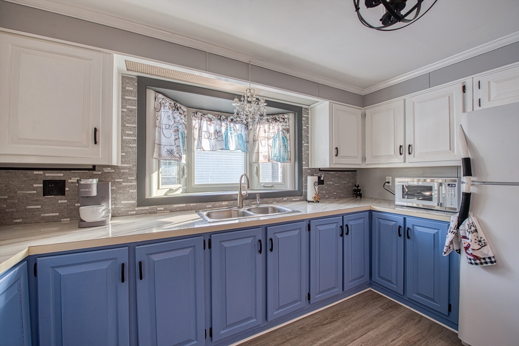191 Red Oak Terrace Taunton, MA 02780 - Photo 9 of 28 a kitchen with stainless steel appliances granite countertop wooden cabinets a sink and dishwasher with wooden floor