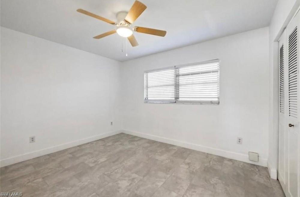 1948 46th Street Southwest Naples, FL 34116 - Photo 9 of 14 Room with wood-finish ceiling fan, window with horizontal blinds, and louvered bifold closet doors