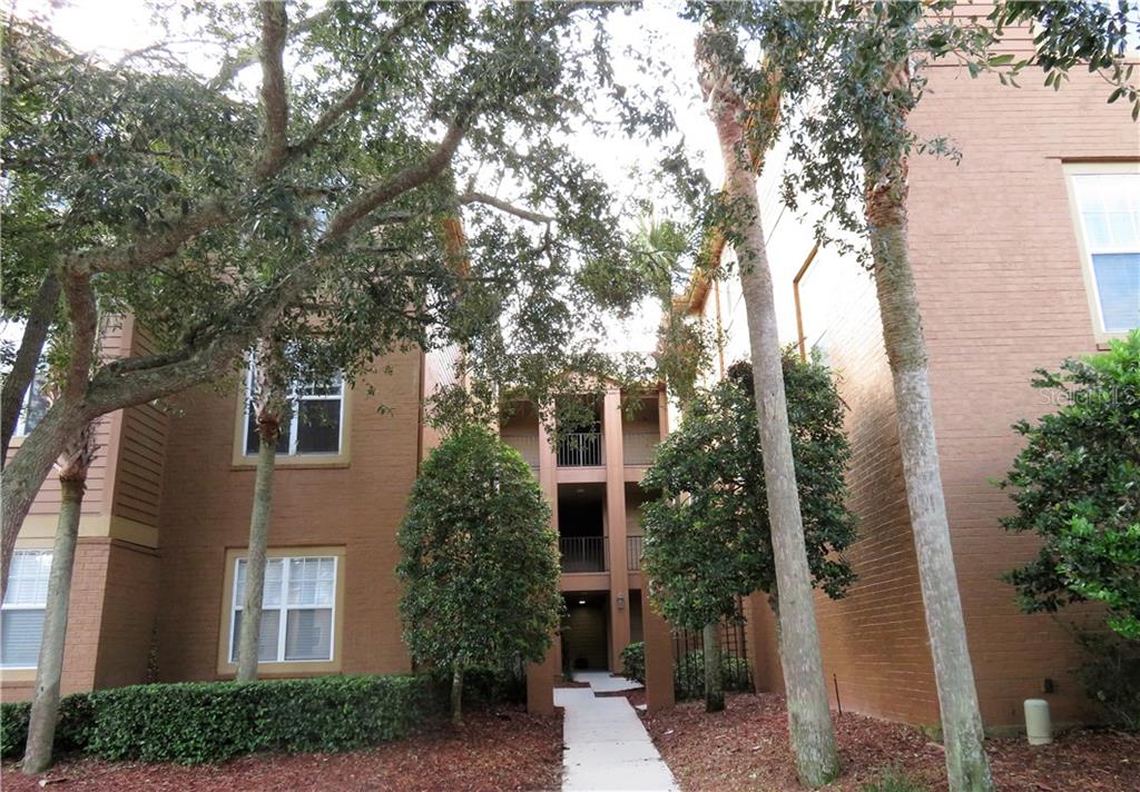 412 Summit Ridge Place, Unit 112 Longwood, FL 32779 - Photo 1 of 1 Entry to building 412. Mature landscaping adds to the appeal.
