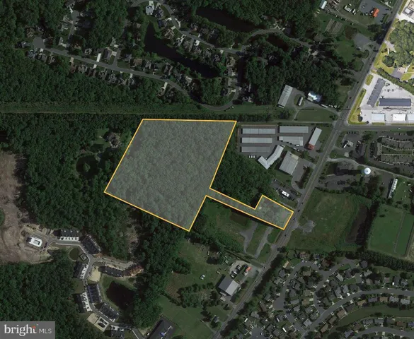 an aerial view of a house with lake view and a yard