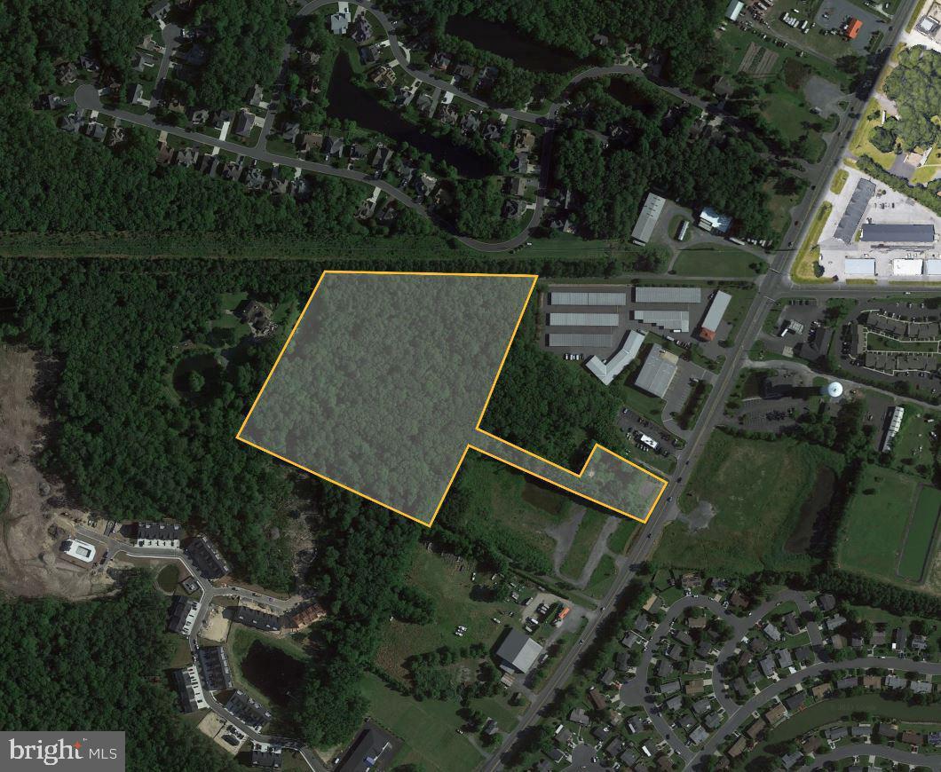 an aerial view of a house with lake view and a yard