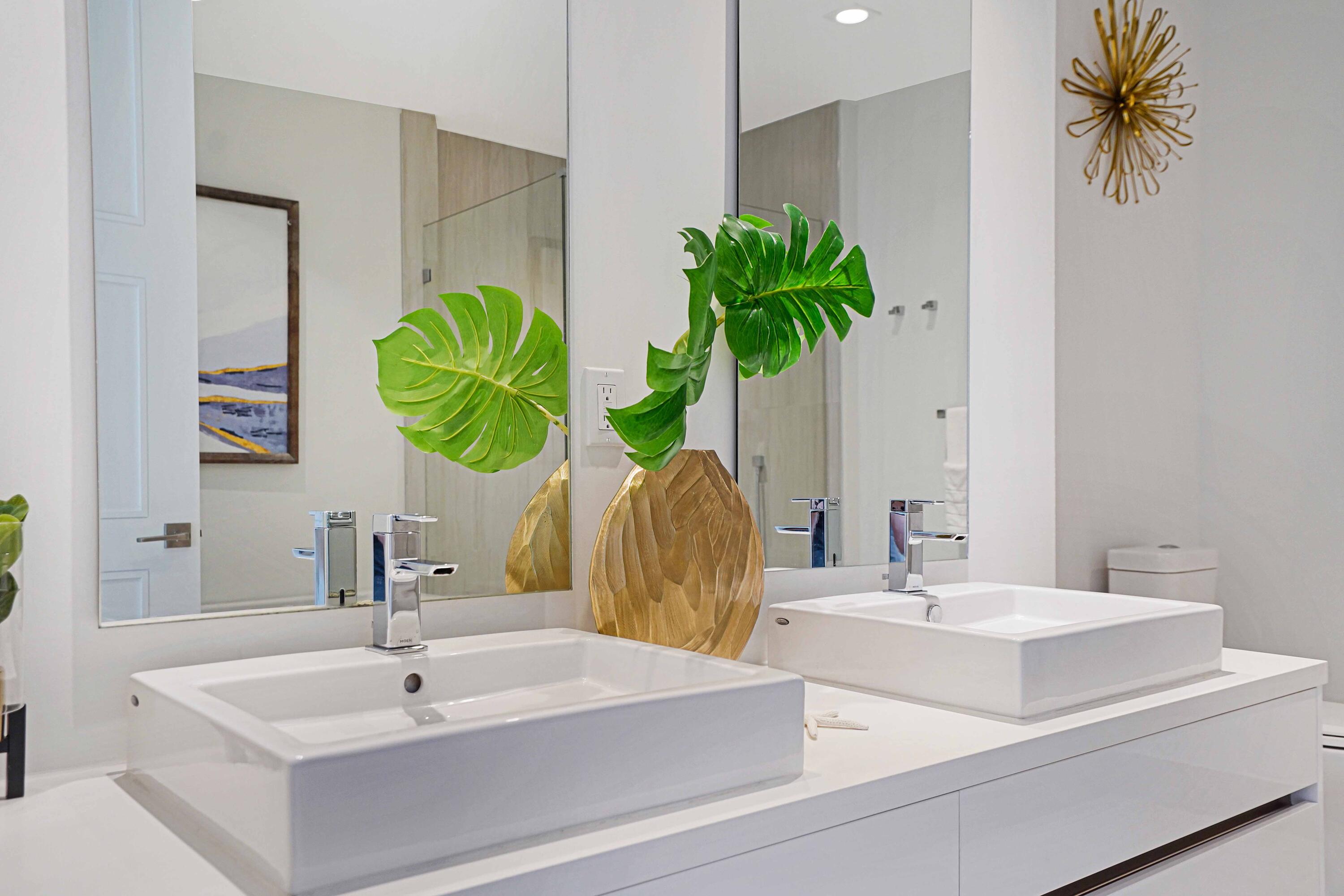 155 East Boca Raton Road, Unit 916 Boca Raton, FL 33432 - Photo 16 of 72 a bathroom with a sink a mirror and a potted plant