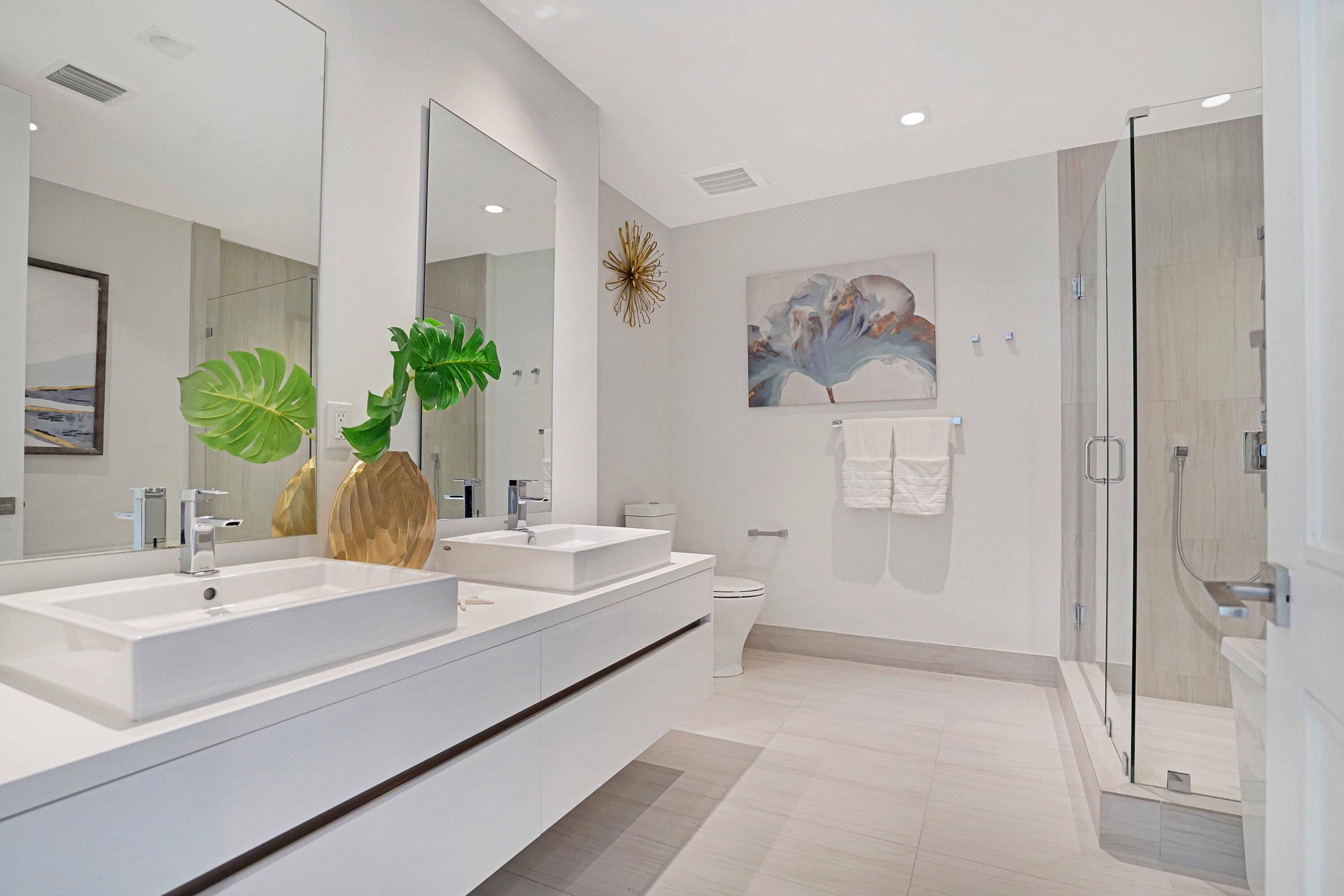 155 East Boca Raton Road, Unit 916 Boca Raton, FL 33432 - Photo 19 of 72 a spacious bathroom with a double vanity sink a mirror and a shower