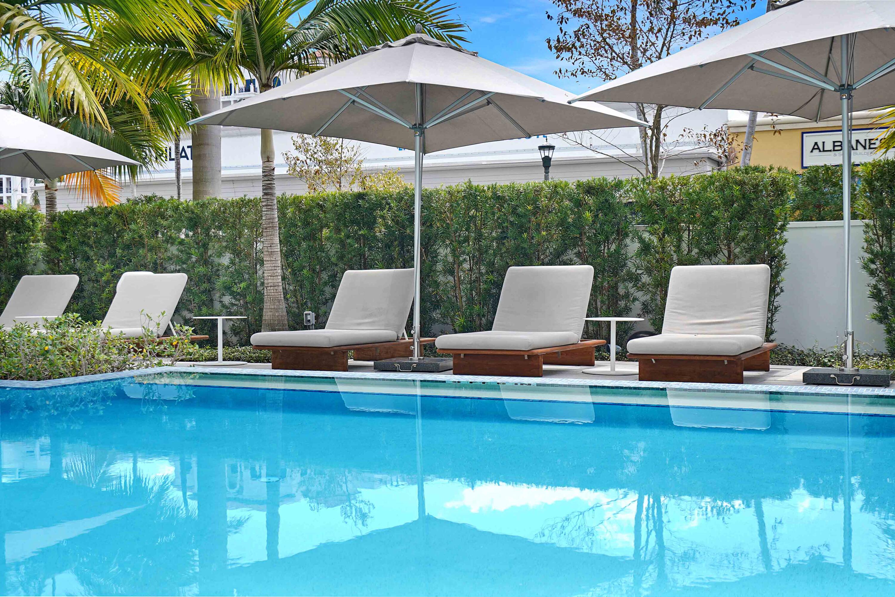 155 East Boca Raton Road, Unit 916 Boca Raton, FL 33432 - Photo 8 of 72 a view of pool with lawn chairs under an umbrella