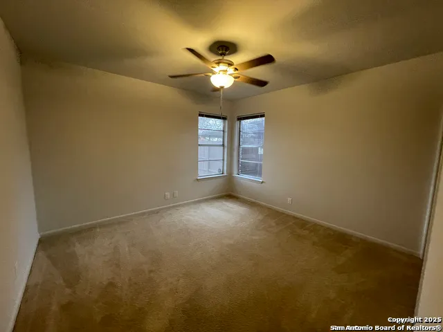 a view of a livingroom with a ceiling fan and window