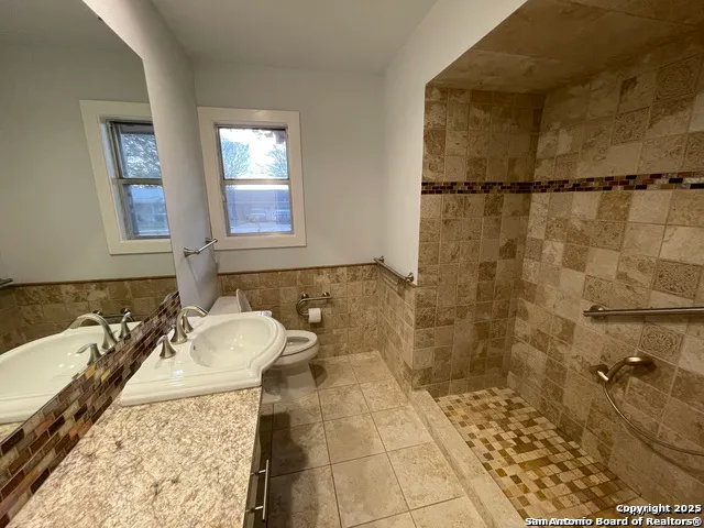 a bathroom with a sink toilet and shower