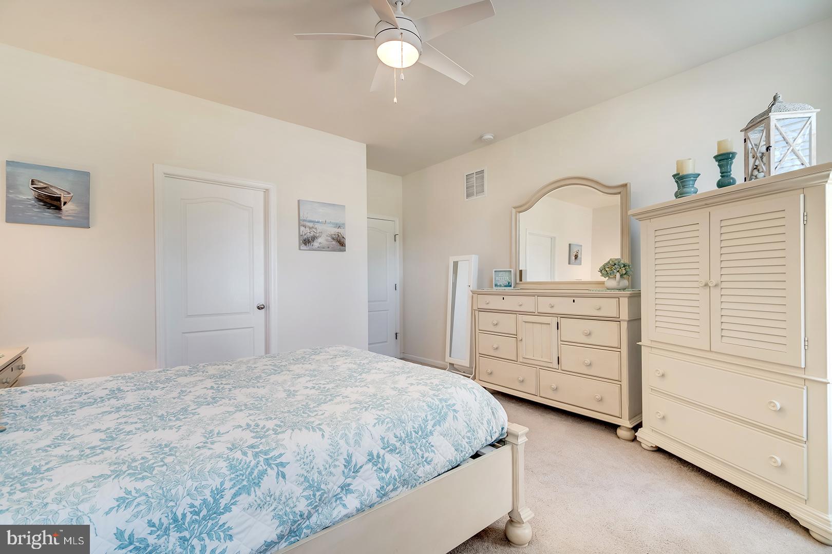 34438 Spring Brook Avenue Lewes, DE 19958 - Photo 19 of 58 a bedroom with a bed and a dresser
