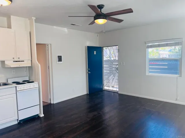 a kitchen with stainless steel appliances white cabinets and a refrigerator