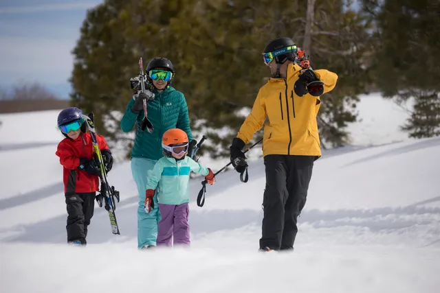 a view of a swimming pool with a table and chairs under an umbrella