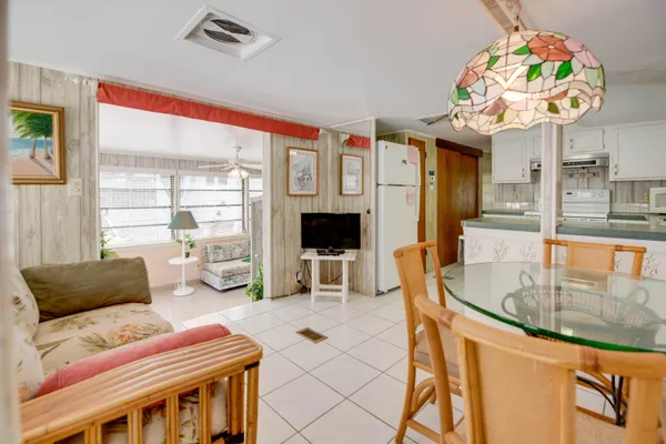 a living room filled with furniture and a large window
