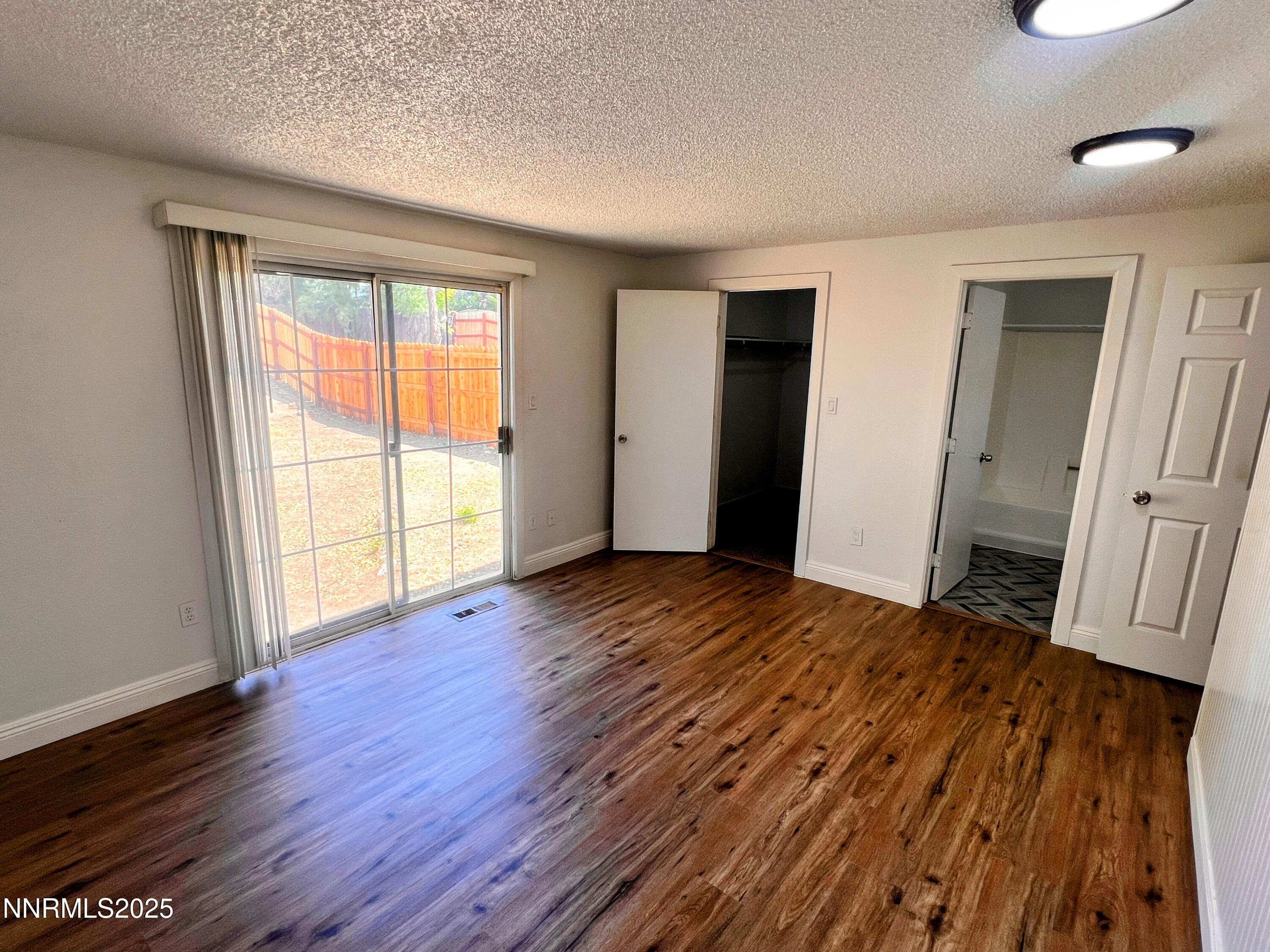 13790 Mt Babcock Street Reno, NV 89506 - Photo 16 of 18 an empty room with wooden floor and windows