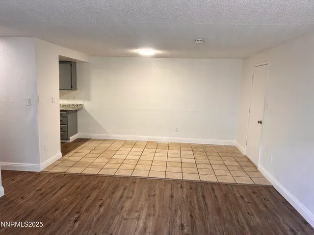 a view of an empty room and wooden floor
