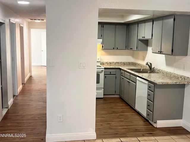 a kitchen with stainless steel appliances granite countertop a sink and a stove top oven