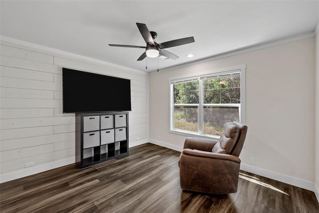 3050 Clater Powell Road Waco, TX 76705 - Photo 24 of 39 a living room with furniture and a flat screen tv