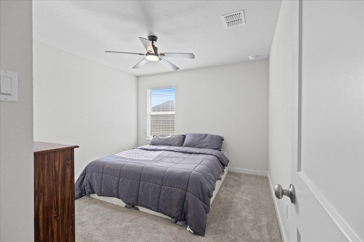 1027 Haystack New Braunfels, TX 78130 - Photo 13 of 15 a bedroom with a bed and a window