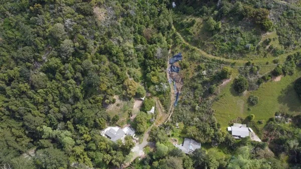 an aerial view of a houses with yard