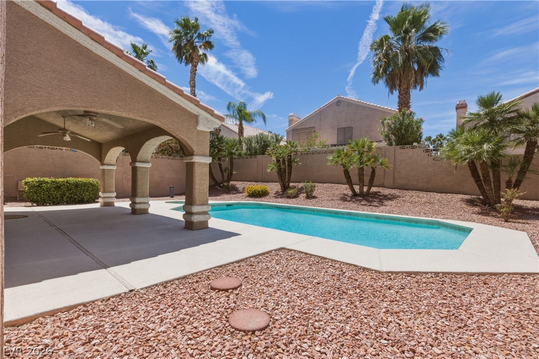 29 Olive Tree Henderson, NV 89074 - Photo 58 of 60 This private outdoor retreat features a covered patio and a refreshing swimming pool, perfect for relaxation.