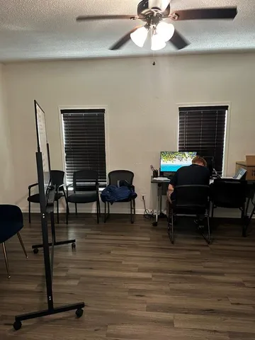 a livingroom with furniture and a piano