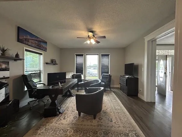 a living room with furniture a window and a flat screen tv
