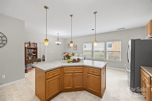 a kitchen with a sink a stove and a refrigerator