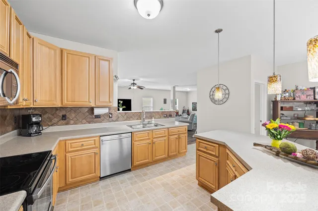 a kitchen with stainless steel appliances granite countertop a sink stove and cabinets