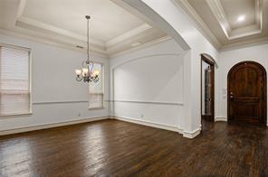 961 Deer Run Prosper, TX 75078 - Photo 5 of 12 a view of empty room with wooden floor and window