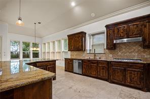 961 Deer Run Prosper, TX 75078 - Photo 7 of 12 a kitchen with stainless steel appliances granite countertop counter space a sink and cabinets
