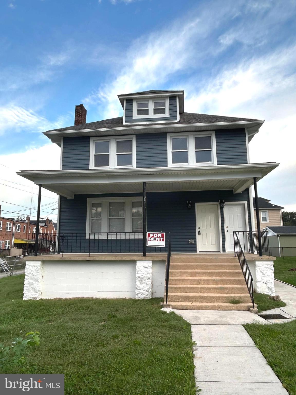 3902 West Rogers Avenue, Unit 2 Baltimore, MD 21215 - Photo 1 of 15 a front view of a house with a yard