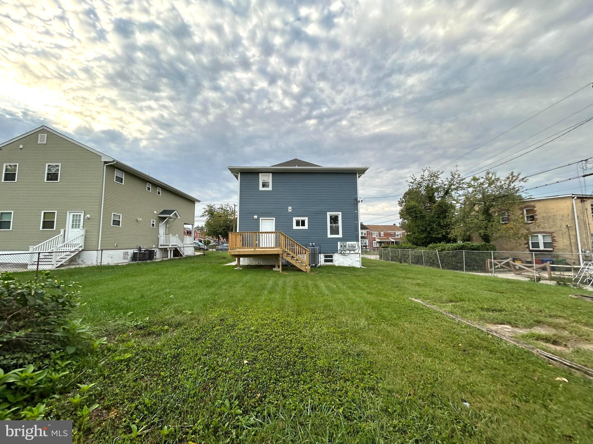 3902 West Rogers Avenue, Unit 2 Baltimore, MD 21215 - Photo 14 of 15 a backyard of a house with table and chairs plants and large tree