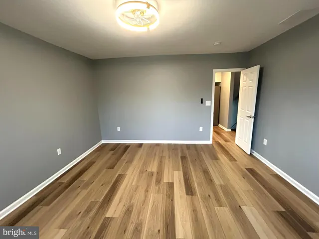 a view of a room with wooden floor