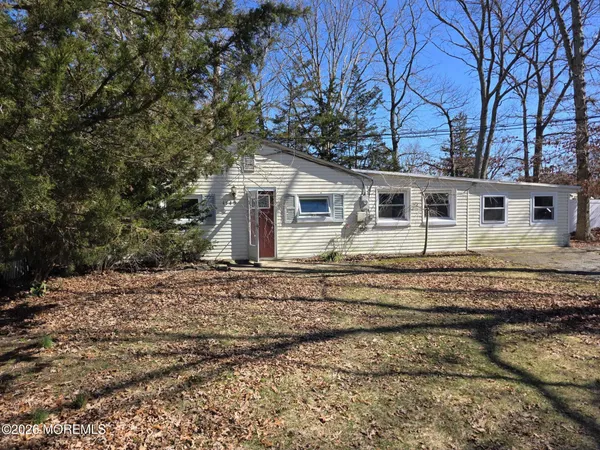 a view of a house with a yard covered in snow