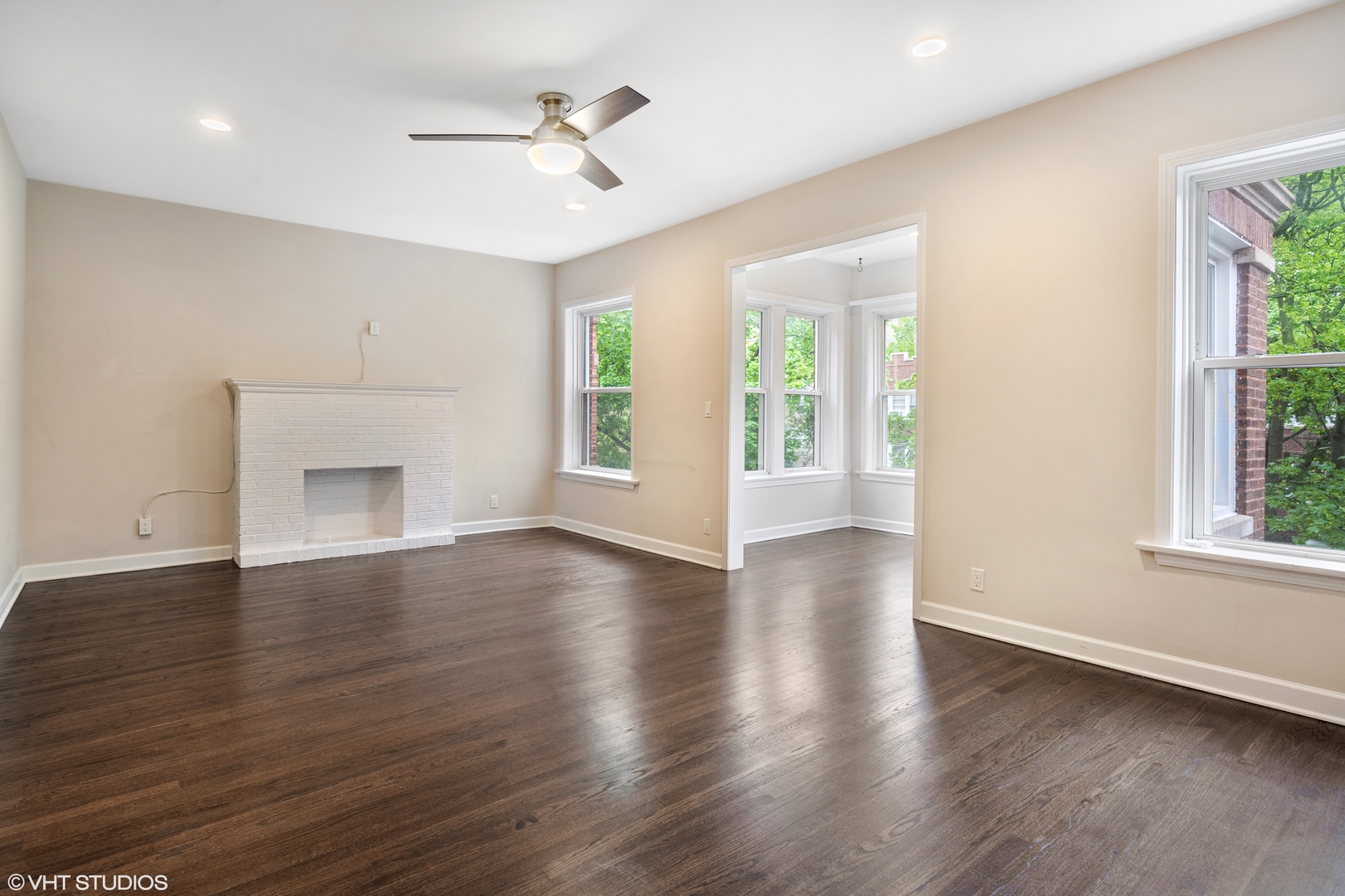 4944 North Drake Avenue, Unit 2 Chicago, IL 60625 - Photo 3 of 13 a view of an empty room with a window and wooden floor